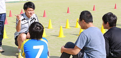 鈴木ゆうきコーチのお話をよく聞く生徒たちの写真 - 障がい児のためのサッカースクール